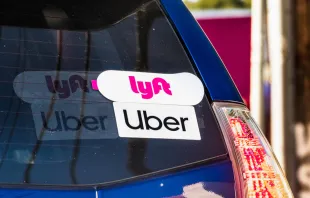 Lyft and Uber stickers on the rear window of a vehicle offering rides in San Francisco Bay Area Sundry Photography/Shutterstock